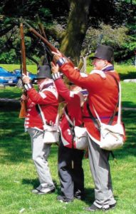 Re-enactors of 2nd Lincoln Militia getting ready to honour Private Richard London by firing off their muskets.